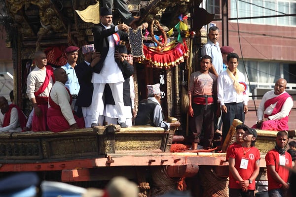 Guthi Sansthan official displays the bejeweled vest known as bhoto to the public from the chariot of Rato Machhendranath during the Bhoto Jatra festival in Jawalakhel on Sunday.