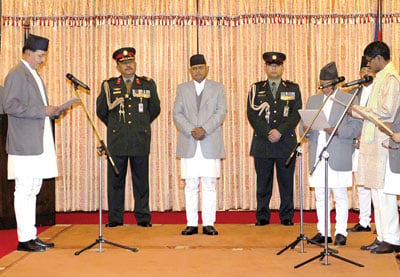 NEW JOB: Newly appointed chief election commisioner Nilkantha Upreti (left) administers the oath of office to four commisionars at Shital Niwas on Monday.