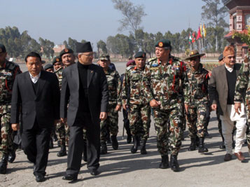 ON DUTY: Chief of Army general Gaurav SJB Rana shows PM Baburam Bhattarai the Nepalese Military Academy at Kharipati Bhaktapur on Tuesday.