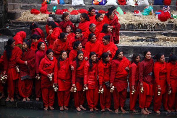 Devotees offer prayers after taking a holy bath in the Bagmati River on the occasion of the month-long Swasthani Brata Katha festival at Pashupatinath Temple, Kathmandu on Friday.