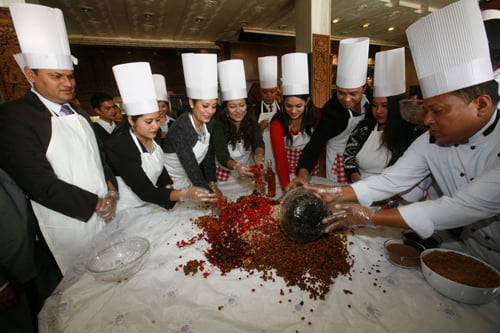 Former Miss Nepal Sugarika KC (third, left) and Usha Khadgi (fourth, left) attend the Christmas cake mixing ceremony at The Everest Hotel on Thursday.
