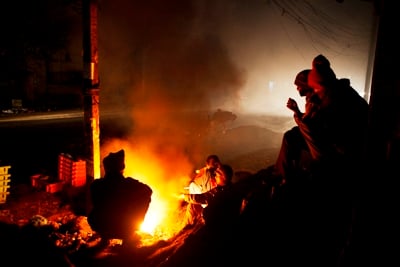 KEEP CLIENTS HAPPY: Tea vendors warm themselves waiting for the first customers of the day at Kuleshwor, on Monday early morning.