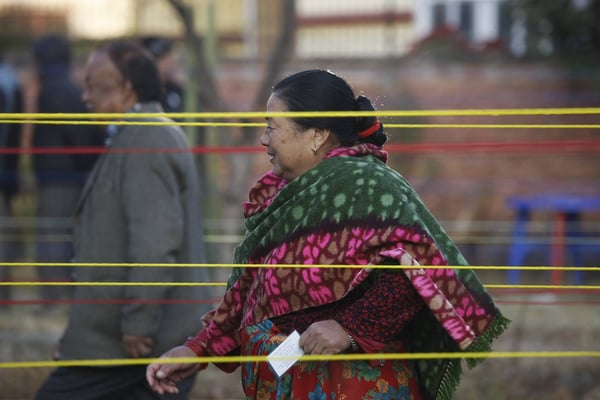 A woman stands in line to cast her vote during the last phase of parliamentary and provincial elections in Mangalbazar on Thursday. More than 12 million voters in 45 districts are eligible to exercise their voting rights in the second phase of the polls.