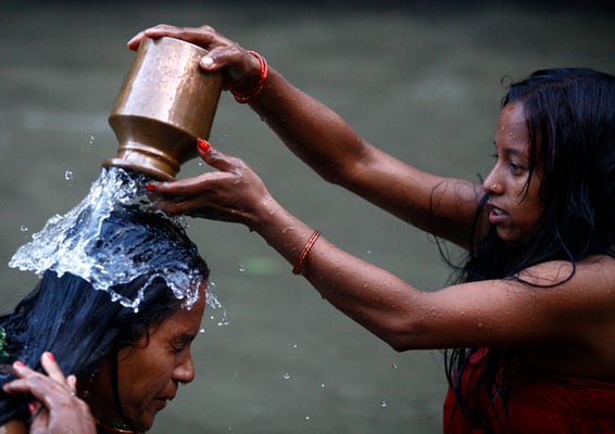 Two women take a holy bath in the Bagmati river at Pashupati temple on the occasion of Rishi Panchami festival on Friday.