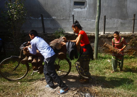 A man and woman balance a pile of firewood on their bicycle after buying it at a government depot in Balkumari on Tuesday. The government started selling firewood to the public from Sunday as a respite from the fuel and cooking gas shortage caused by the ongoing blockade.