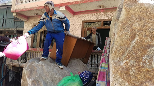 Lukman BK sifts through furniture from a landslide-damaged house at Tatopani on Tuesday. More than half of the residents of Tatopani have moved out to neighbouring villages or to Kathmandu after the April earthquake.