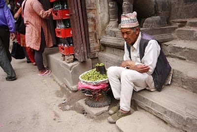 SWEET DREAMS: An old man dozes off while waiting for passers-by to purchase his amla (gooseberries) at Lagankhel on Tuesday.