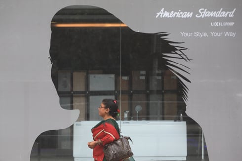 THAT WAY: A woman walks past an electronics showroom in Tripureswor on Sunday evening.