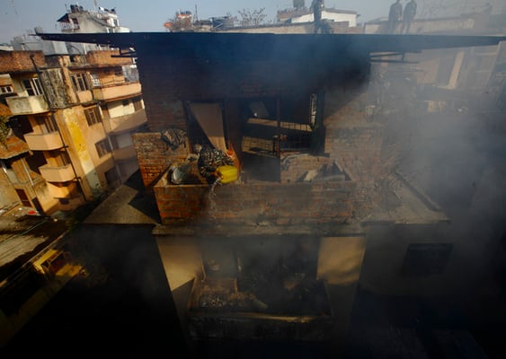 Nepal Army personnel try to douse fire caused by a short-circuit at an electronics warehouse in Basantapur on Wednesday.