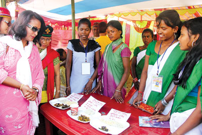 MUST BE YUMMY: Singer Kunti Moktan (left) greets Dhimal girls selling their traditional food at the first Mechinagar indigenous festival in Jhapa on Saturday.
