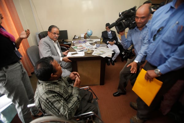 Bhoj Raj Shrestha (left), member secretary of Independent Living Center for Persons with Disabilities, discusses their rights with political leaders at Singha Darbar on Thursday.