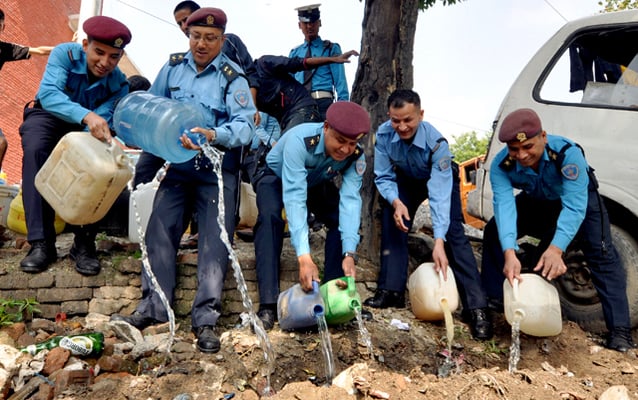 Nepal Police officers destroy illegal homemade liquor in Kathmandu on Thursday. The police seized a total of 900 bottles of homemade liquor bearing labels of genuine liquor companies from various restaurants and hotels.