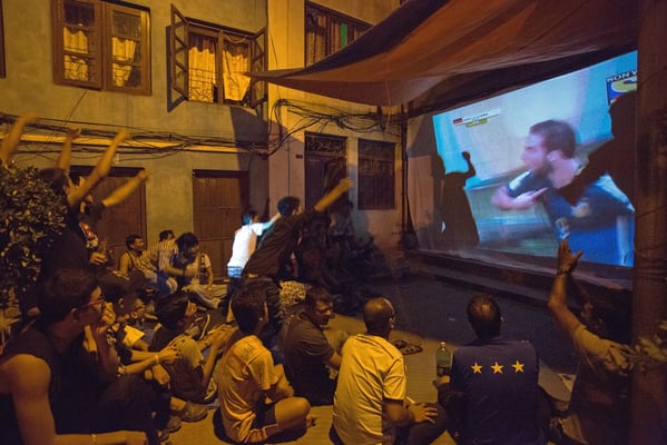 Residents of Bu Bahal in Patan gather at their community courtyard to enjoy a public screening of the FIFA World Cup Finals.