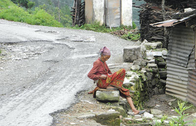 KEEP WAITING: An old woman sits down next to the road connecting Kulekhani Dam near Hetauda.