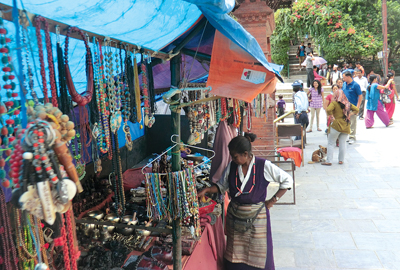 PICK ME: A vendor arranges products in her souvenir kiosk in Kathmandu.