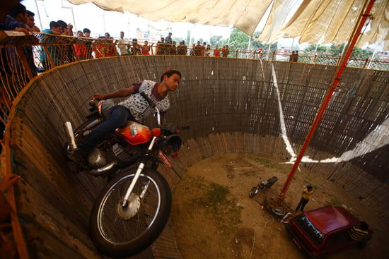 A stuntman rides a motorcycle inside the well of death at Bhaktapur on Monday.