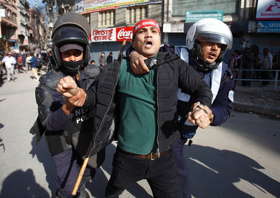 Police personnel detain a strike enforcer in Kalimati on Wednesday. The strike was called by a struggle committee of people opposed to road expansion drive in the Kathmandu Valley.