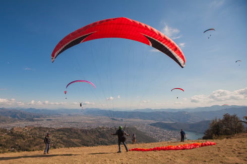 FLYING HIGH: Paragliders take off from Sarangkot hill in Pokhara on Monday. Paragliding has become one of the most popular adventure sports in Pokhara.