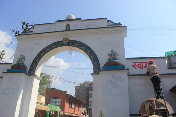 A man paints Patan Dhoka in Patan on Sunday ahead of the Newari New Year which falls during Tihar.