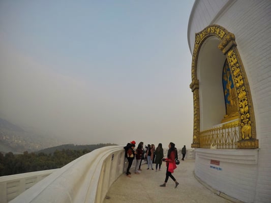 Visitors take in the view at the World Peace Pagoda in Pokhara on Sunday.