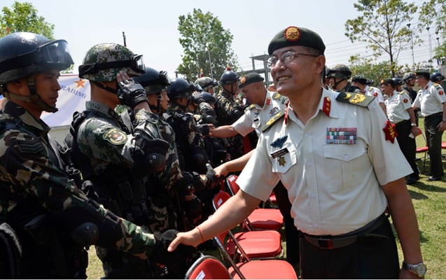 Nepal Army Major General Binod Shrestha shakes hands with participants in the first Nepal-China joint military training in Kathmandu on Sunday.