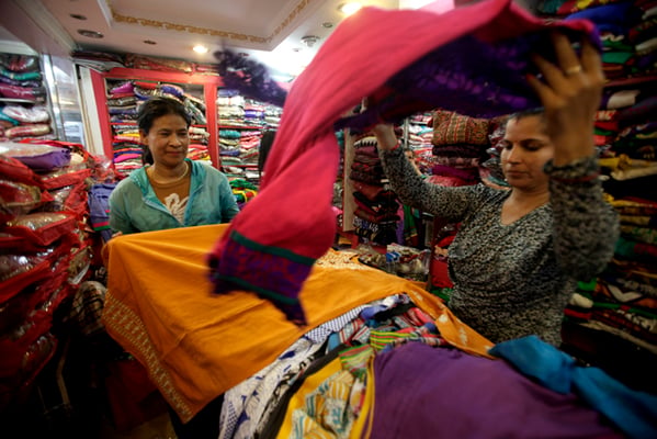 A woman chooses clothes during a festival sale at a clothing store in New Road, Kathmandu on Tuesday.