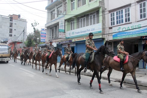 Nepal Army soldiers ride on horses along the Baneswor-Anamnagar road as part of a morning drill.