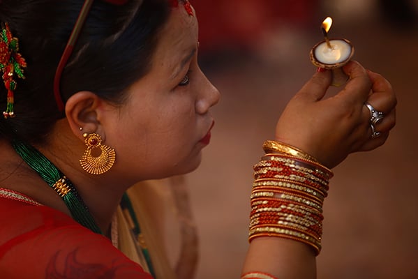 A women performs a ritual to celebrate Tij at Krishna Mandir in Lalitpur on Thursday.