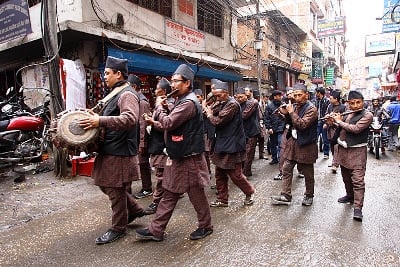HERE COMES THE BRIDE: A band plays music and leads a wedding car down the street in Thamel on Tuesday afternoon.