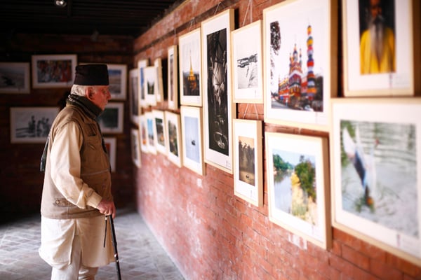 A visitor observes photographs and paintings during an exhibition titled “Bangladesh through Clicks and Brushes” by Mirzapur Ex Cadet Association (MECA) of Bangladesh held at Patan Museum, Lalitpur on Monday. The exhibition runs from 26-28 March.