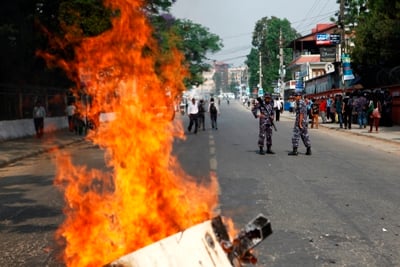 NO-NO: Police watch the protest by student union affiliated to CPN-Maoist against the recommendation of Lokman Singh Karki as chief of CIAA at Exhibition Road on Monday.