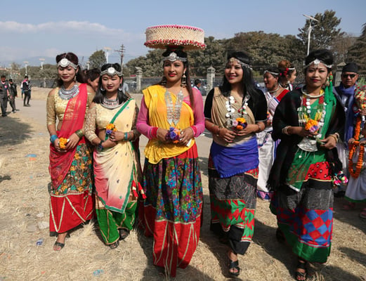 Women from Tharu community dressed in traditional attire get ready to celebrate Maghi festival in Tundikhel, Kathmandu on Monday.