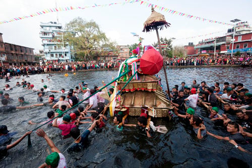 The local people in Handigaun, Kathmandu pull a chariot of the goddess Tundaldevi floating on a pond during Gahana Khojne Jatra.