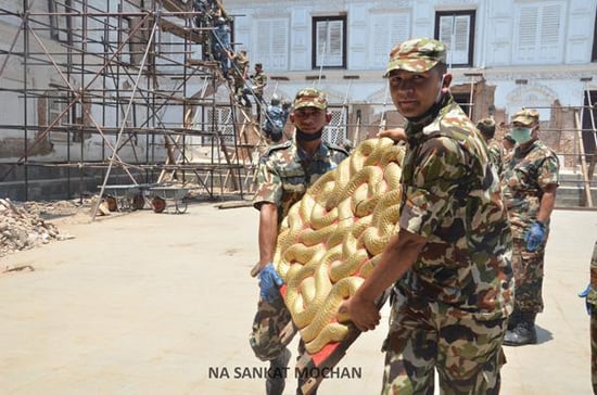 Nepal Army soldiers rescue a portion of the golden serpent throne on Wednesday from the Hanuman Dhoka Palace Museum which was damaged in the earthquake.