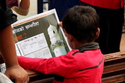 INFORMATION FOR ALL: A boy reads a copy of a gratis distributed newspaper in Basantapur on Friday