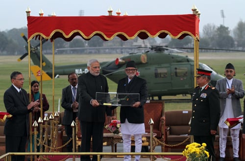 Prime Minister of India Narendra Modi handing over a replica of an Advanced Light Helicopter, Mark III (Dhruv) to Prime Minister Sushil Koirala on Tuesday.