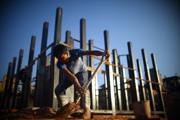 Ram Singh Tamang,32 works at the reconstruction site of the Rato Machindranath temple at Bungamati on Wednesday.