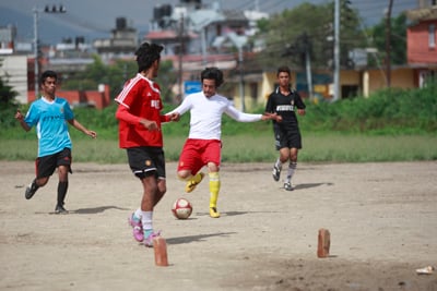 SWIFT MOVES: Boys play football at the open grounds of Patan Campus in Lalitpur on Thursday.