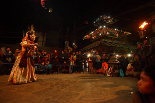 A masked performer dances during the first day of Dyah Lwakegu festival at Nyata on Friday.