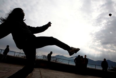 CORNER KICK: A man kicks a “chungi”, a rubber ball, while playing with his friend at Swoyambhunath Stupa in Kathmandu on Tuesday.