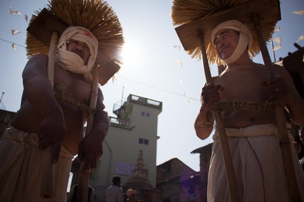 Devotees dressed as the Hindu God Madhav Narayan carrying poles of straw during the Madhav Narayan festival celebrations in Thecho on Saturday.