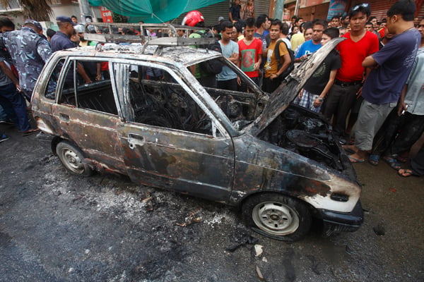 CPN Maoist cadre set five vehicles ablaze, including this taxi in Naya Bazaar of Kathmandu, to enforce their general strike on Friday.