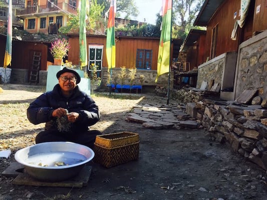 A 76-year-old Tibetan refugee, Gompo Tsewang, cleans butter lamps in a camp in Syabrubesi, Rasuwa on Monday.