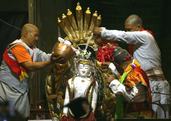 Priests perform the ritual purification of Seto Machindranath in Janabhal on Tuesday.