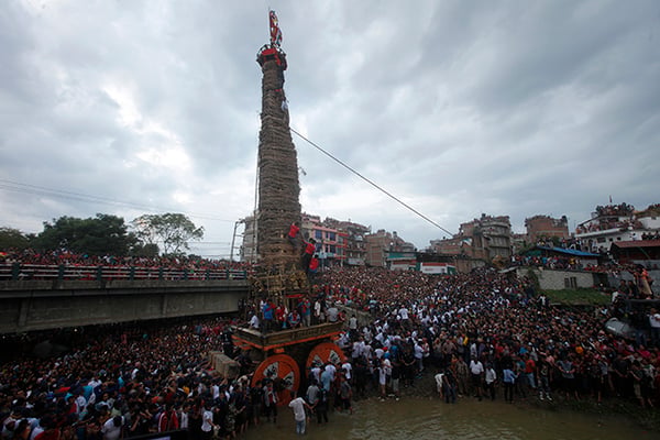People gather around to celebrate the Rato Machhindranath festival at Nakhu river on Wednesday. The chariot was rebuilt after the April 25 earthquake halted the festivities.