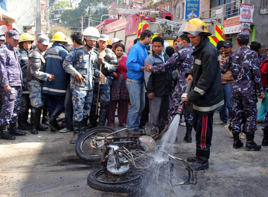 UNDER CONTROL: Fire fighters try to douse a burning motorcycle that was set on fire at Sankhamul by members of the 16 student unions who called a bandh in Kathmandu on Wednesday.