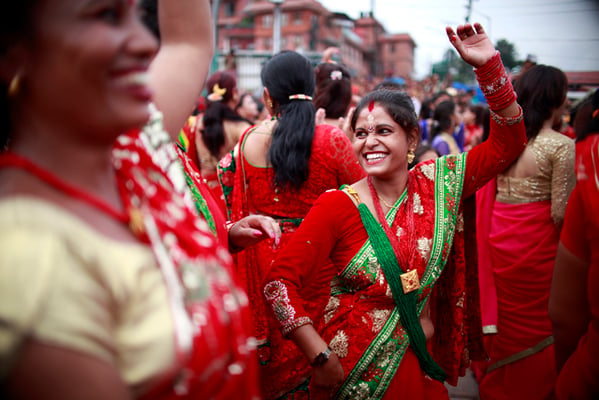 Women sing and dance at the Pashupatinath Temple premises to mark the Tij festival in Kathmandu on Sunday.