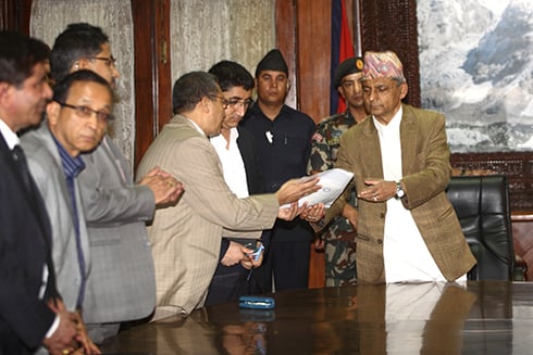 HELPING HANDS: Representatives of insurance companies hand Chairman of Ministers' Council Khil Raj Regmi a cheque of Rs 12,700,000 as aid to flood-hit areas across Nepal, on Monday.
