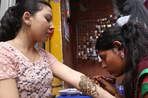 An artist applies henna on a girl's hand on Friday a day before the onset of the Nepali month of Shrawan.