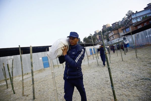 A temporary police personnel carries election supplies to a polling station at Shree Krishna Ratna Ganga Secondary School in Chautara, Sindhupalchowk on Saturday, a day before the election.